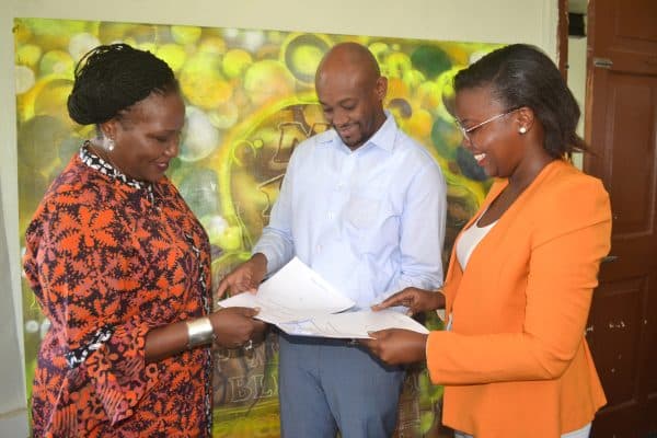 ADMI CEO Laila Macharia exchange MOU with CEO of Swahili pot and a representative from GYON in Mombasa