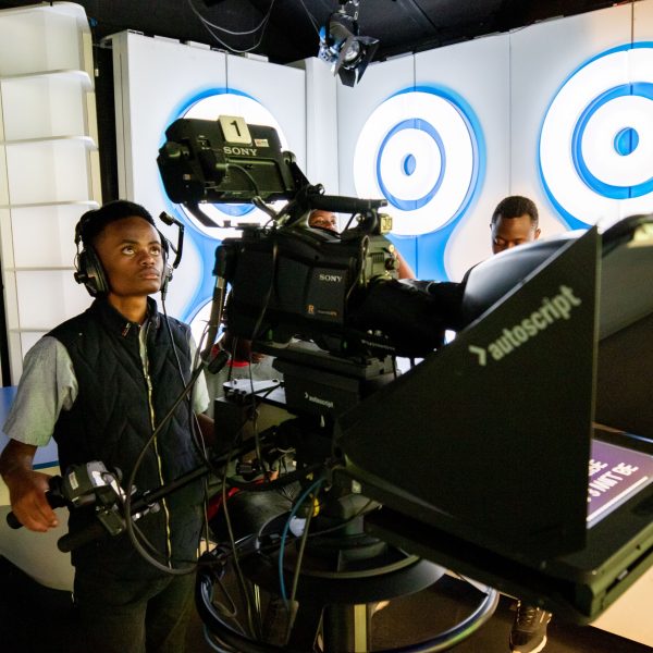ADMI student operating a camera in a TV studio